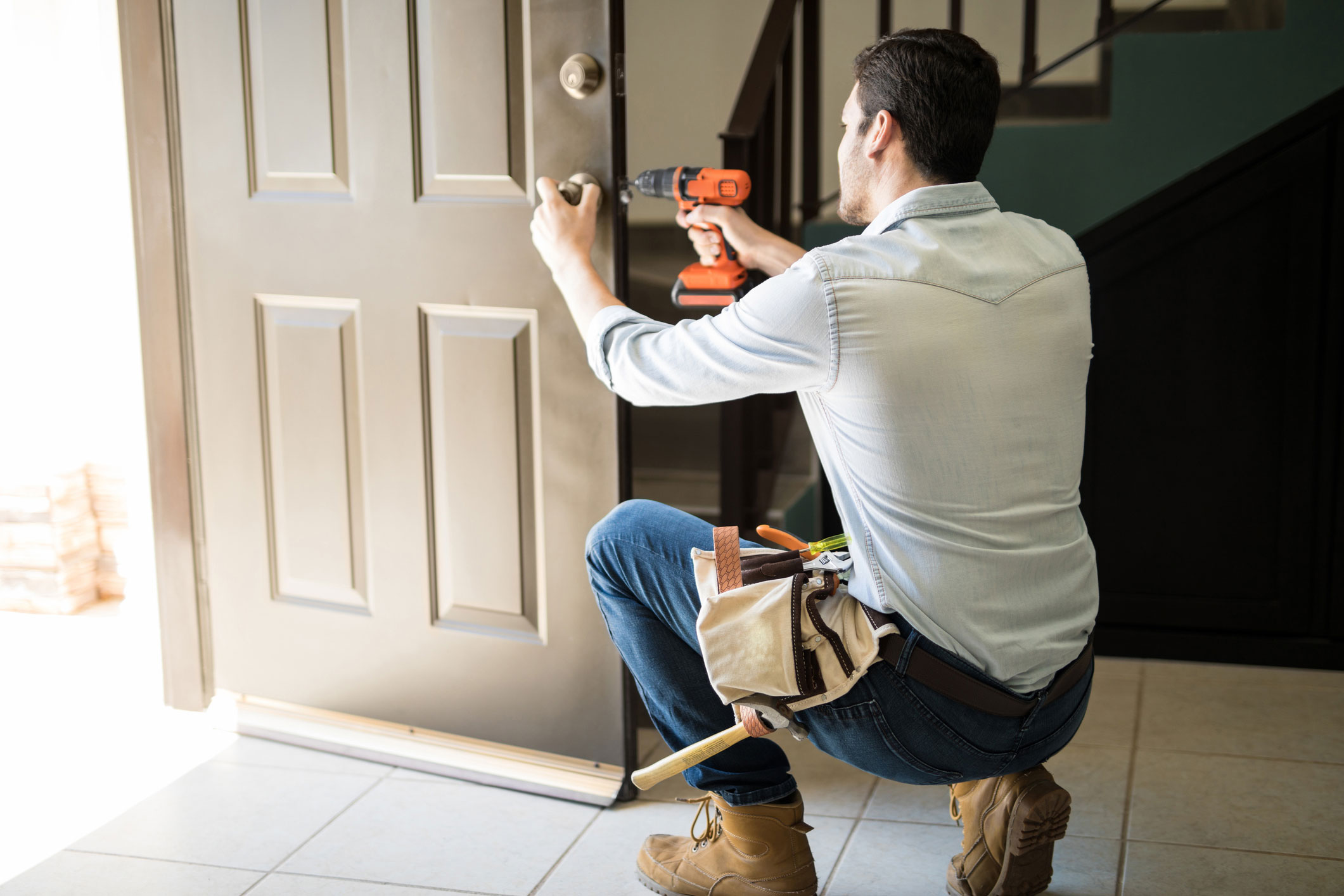 Handyman repairing door knob